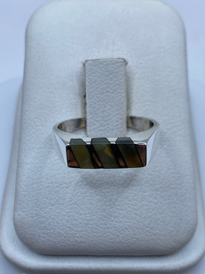 Anillo de plata minimalista con piedra natural rectangular, visto desde arriba en estuche blanco
