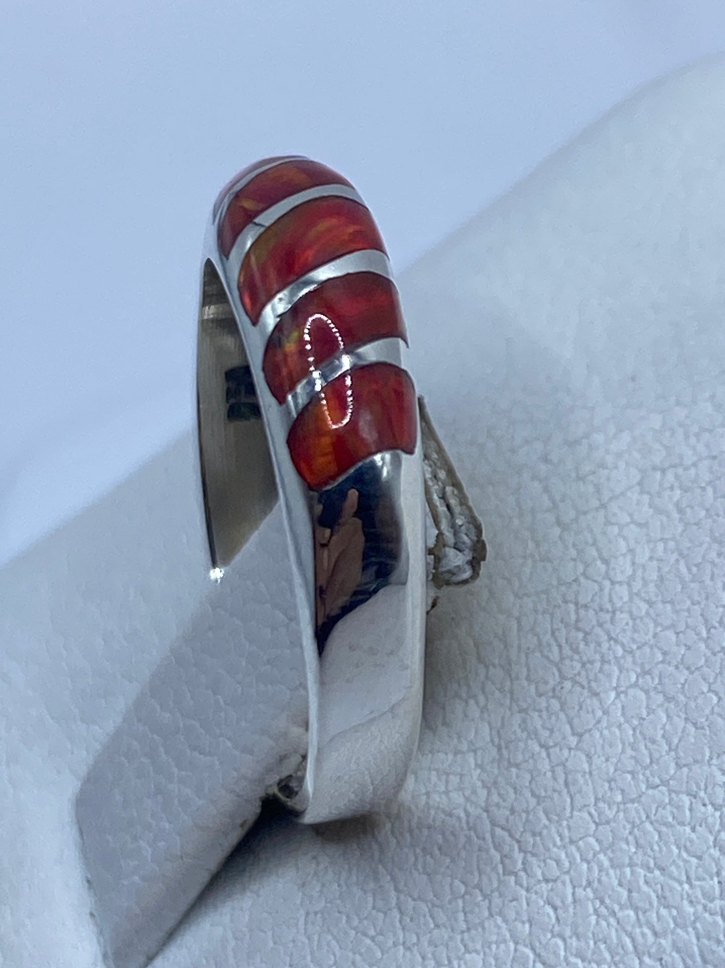 Anillo Ópalo de Fuego en el dedo, mostrando el brillo natural de la piedra