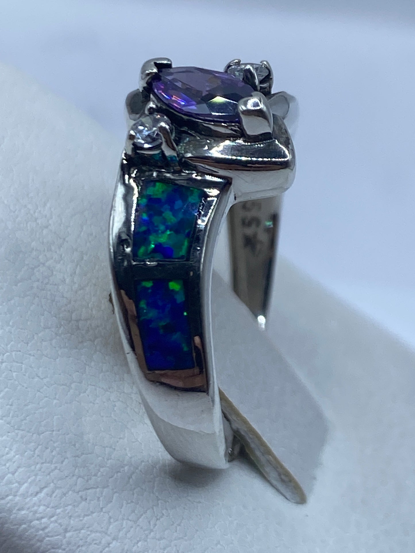 Vista lateral del anillo con ópalo de fuego en la mano de una mujer
