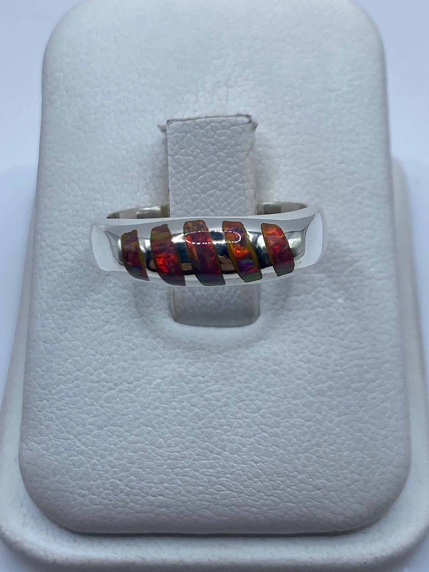 Anillo de plata .950 con ópalo de fuego multicolor mostrando reflejos iridiscentes en la mano
