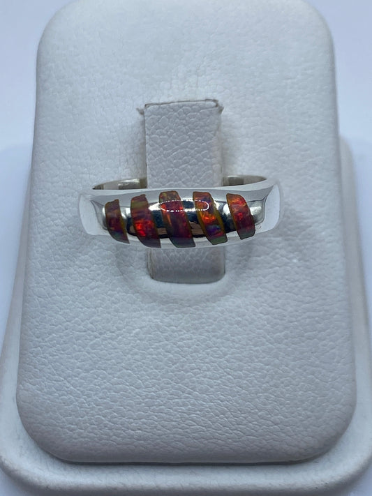 Anillo de plata .950 con ópalo de fuego multicolor mostrando reflejos iridiscentes en la mano
