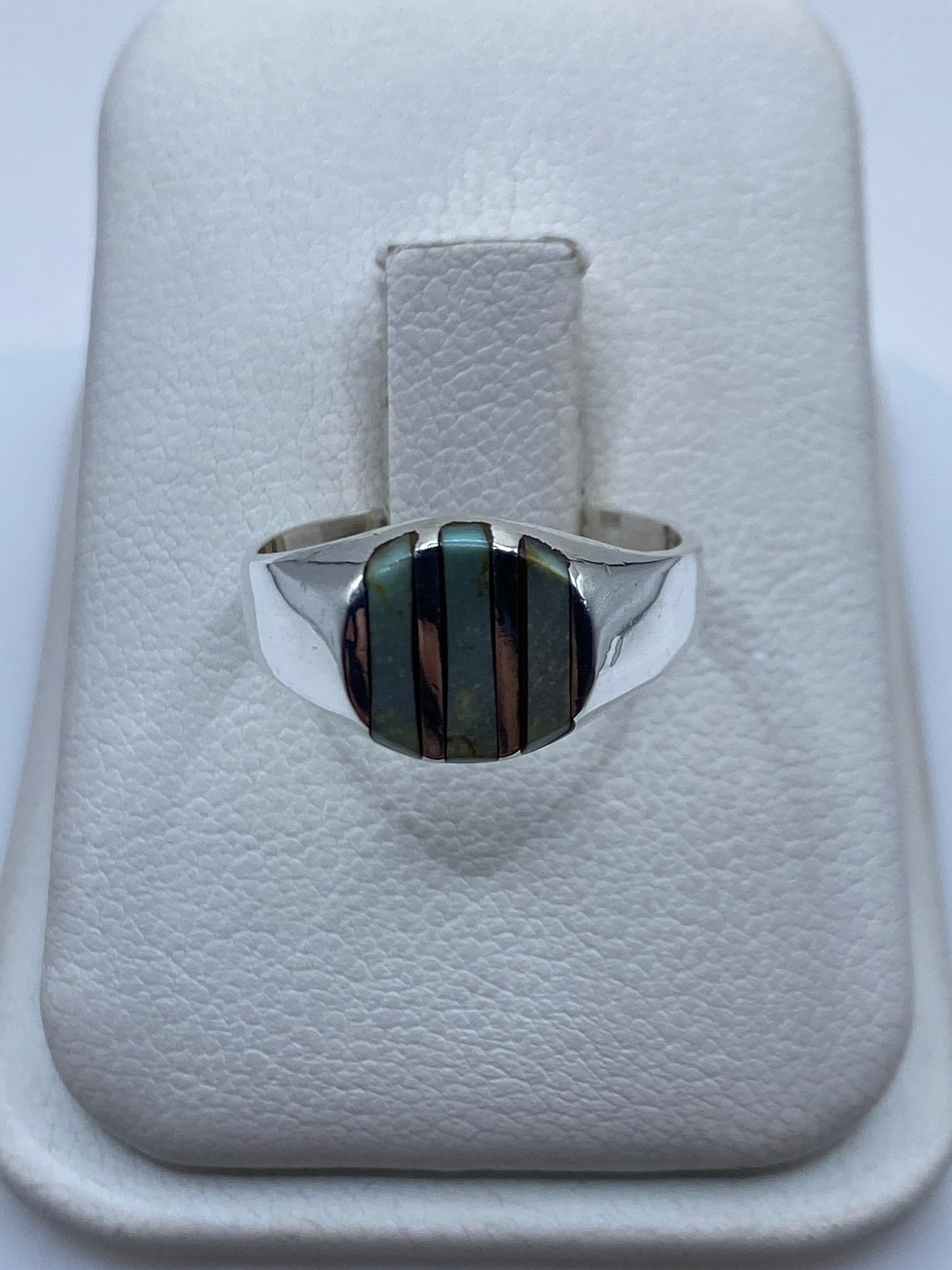 Anillo de plata con onix negro en mano de mujer, vista frontal del engaste