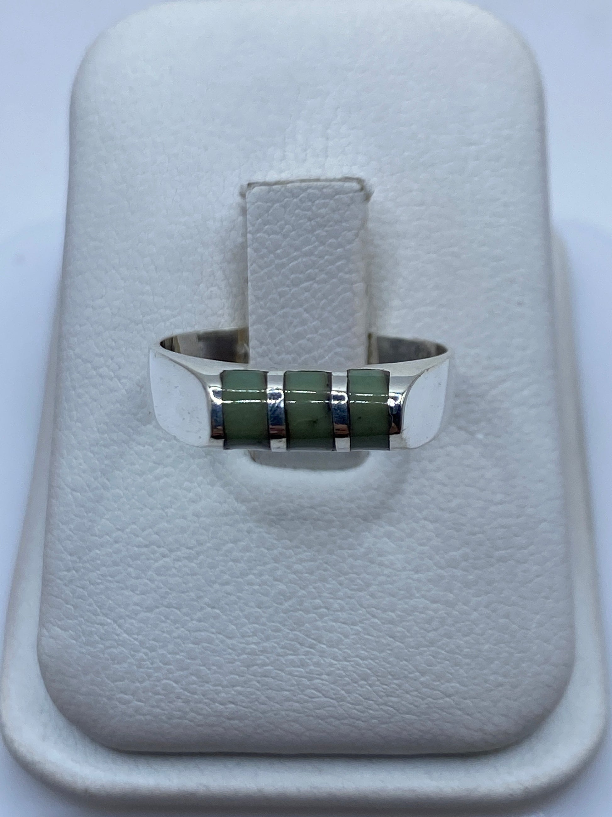 Anillo de plata solitario con piedra engastada, vista frontal sobre estuche blanco