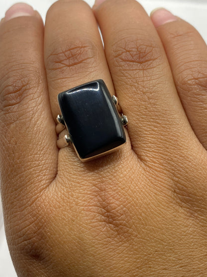 Anillo de ónix y plata sobre fondo blanco con sello 925 visible en la banda