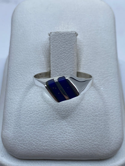Anillo de plata con piedra azul en presentación sobre estuche blanco