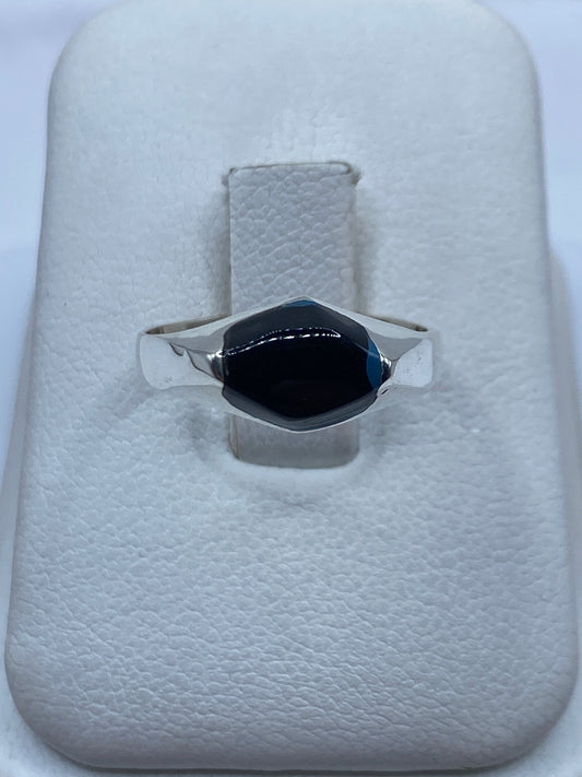 Anillo de plata con ónix negro solitario sobre estuche blanco