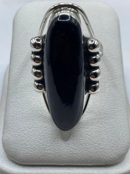 Anillo de plata .925 con ónix negro pulido, visto desde arriba en estuche blanco