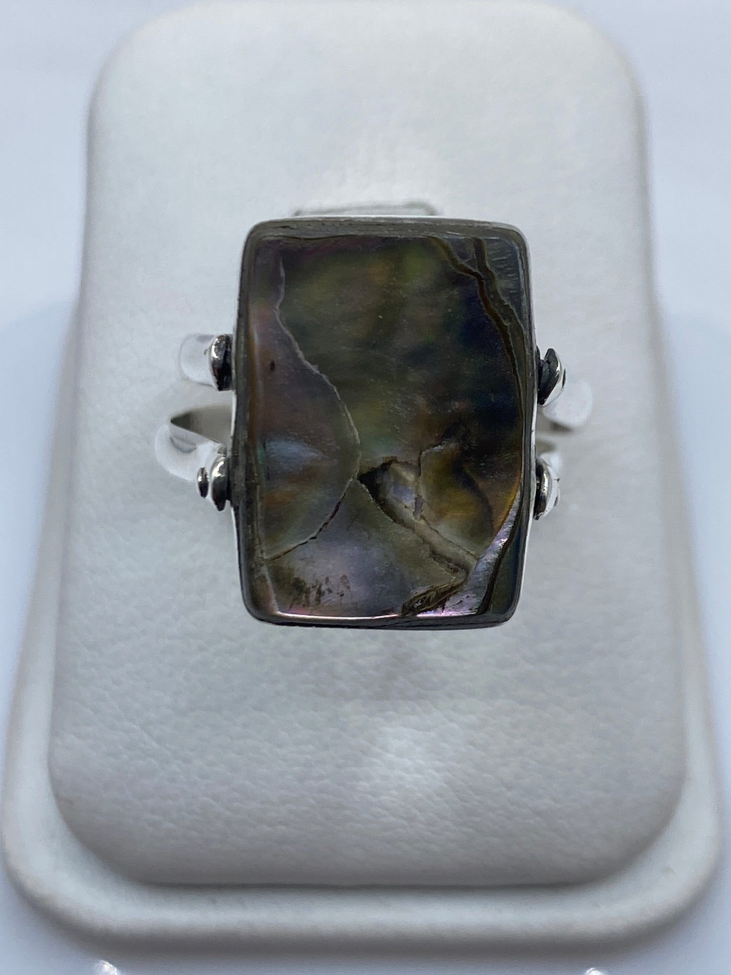 Detalle lateral del anillo mostrando la banda de plata y el engaste del ónix