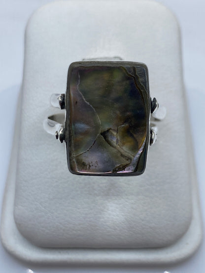Detalle lateral del anillo mostrando la banda de plata y el engaste del ónix