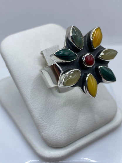 Anillo ajustable de malaquita en la mano de una mujer, mostrando las vetas verdes naturales