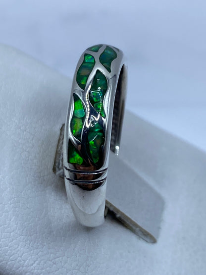 Anillo de ópalo de fuego verde puesto en dedo, mostrando el fuego natural