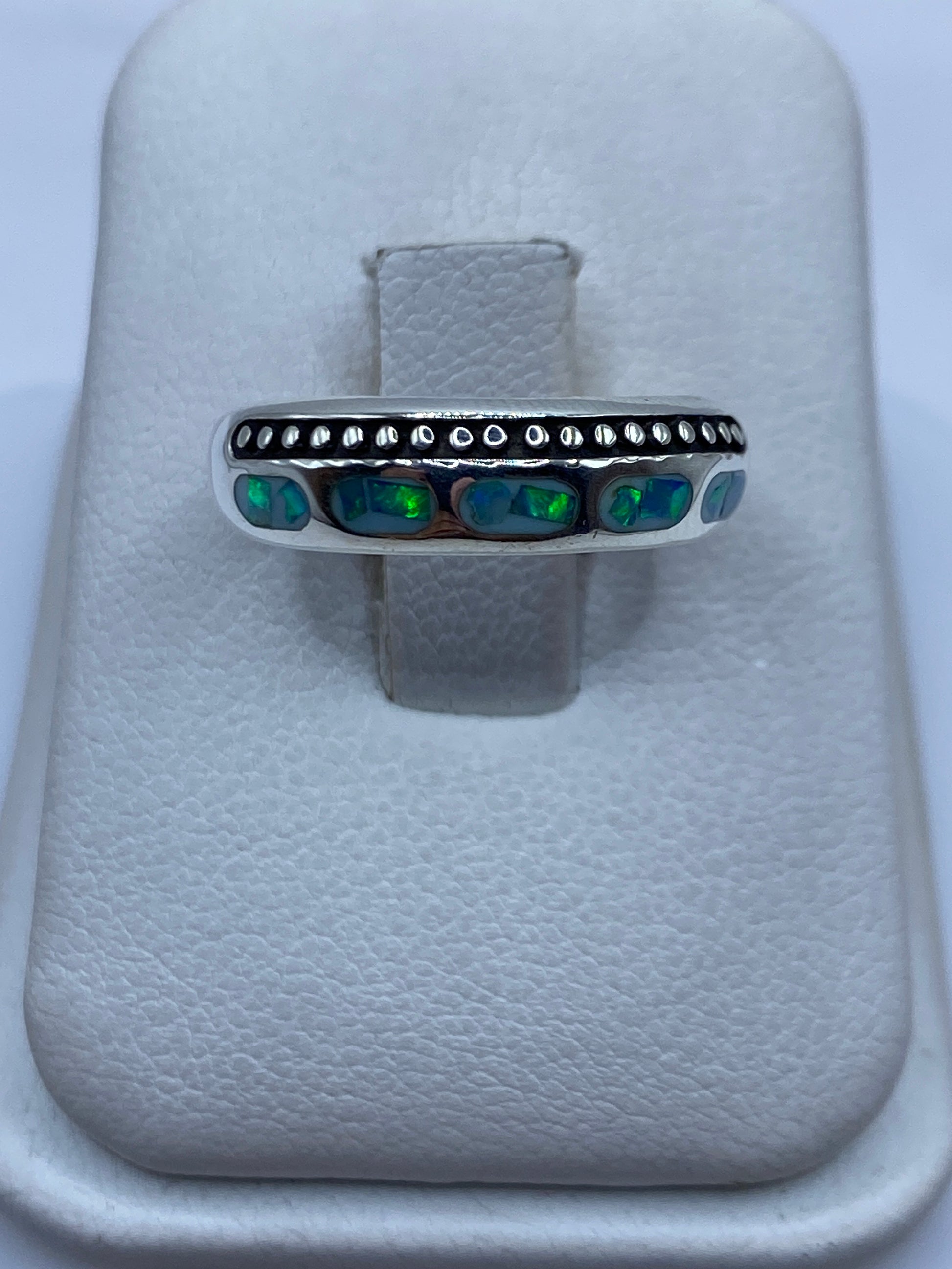 Anillo de plata con ópalo de fuego azul cielo y detalles perlados, visto de frente