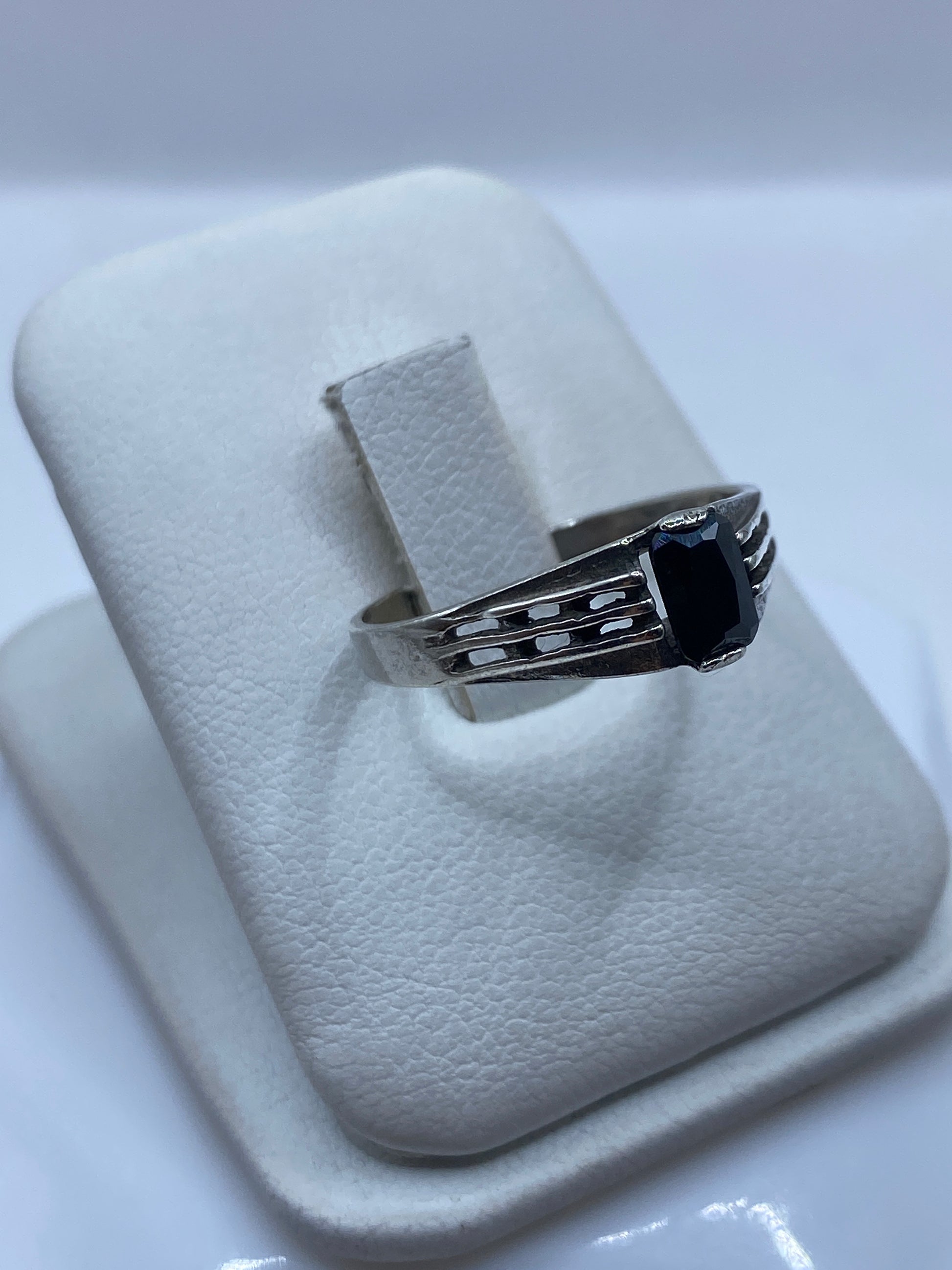 Detalle lateral del anillo minimalista en plata .925 mostrando el engaste de la circonia negra