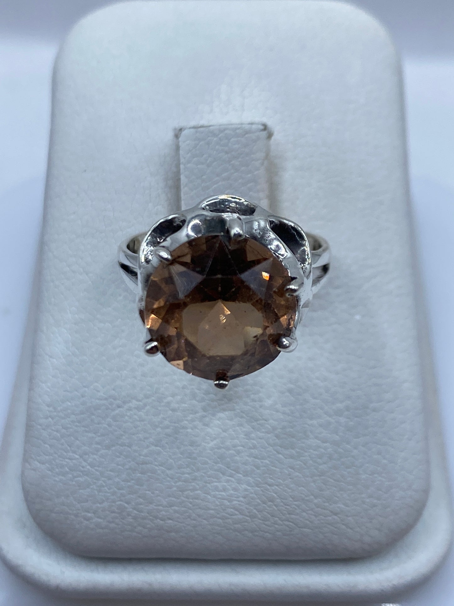 Anillo de plata solitario con circonia café visto de frente, mostrando el brillo cálido de la piedra