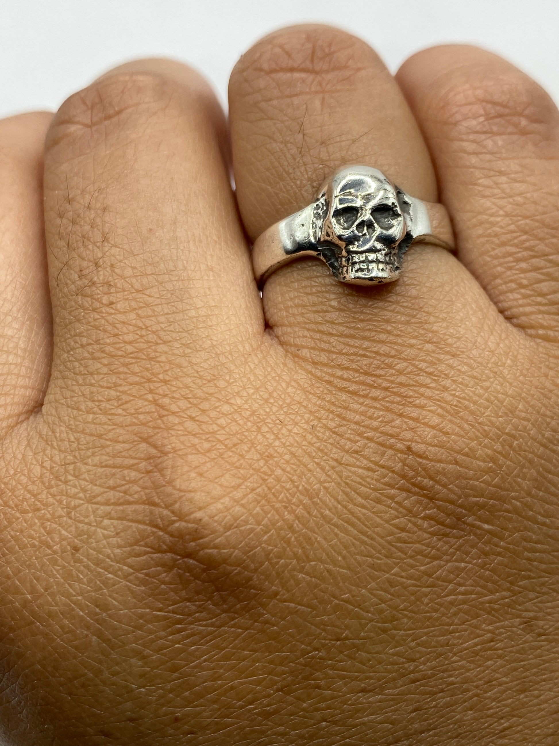 Detalle de la calavera pulida en plata .925 sobre fondo gris claro