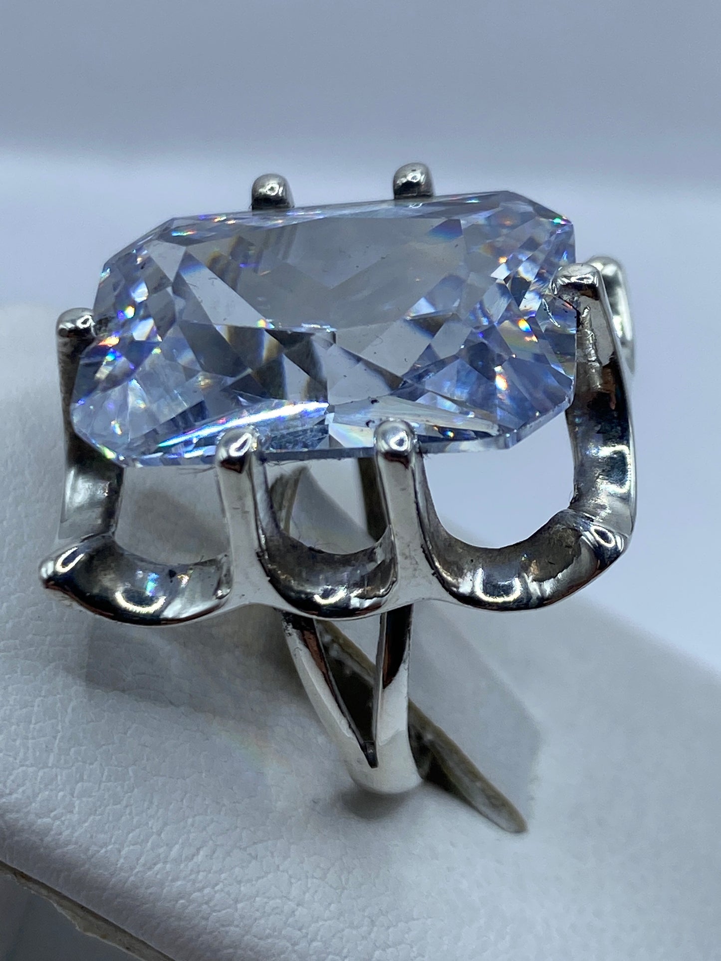 Anillo solitario en la mano de una mujer mostrando el juego de luz en la piedra