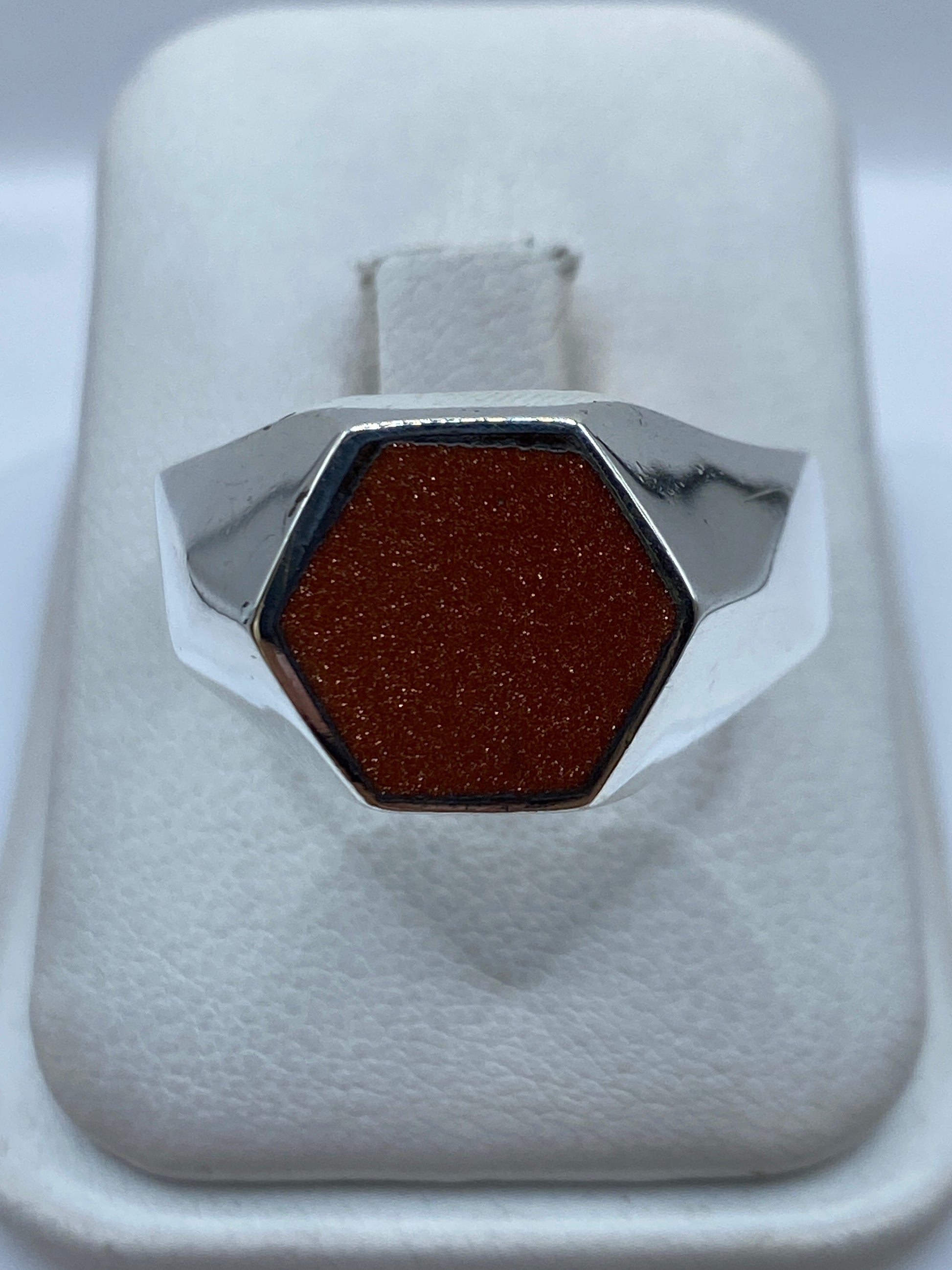 Anillo sello de plata .925 con piedra engastada, vista frontal en estuche blanco