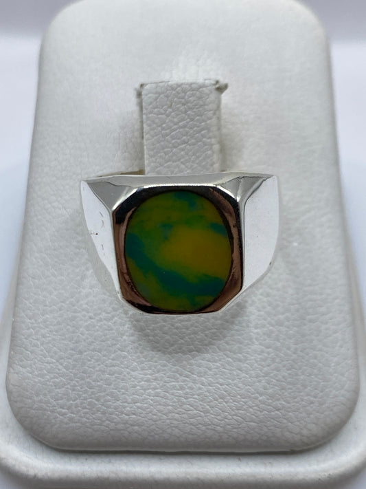 Anillo de plata .925 con piedra amarilla engastada en la mano de una mujer