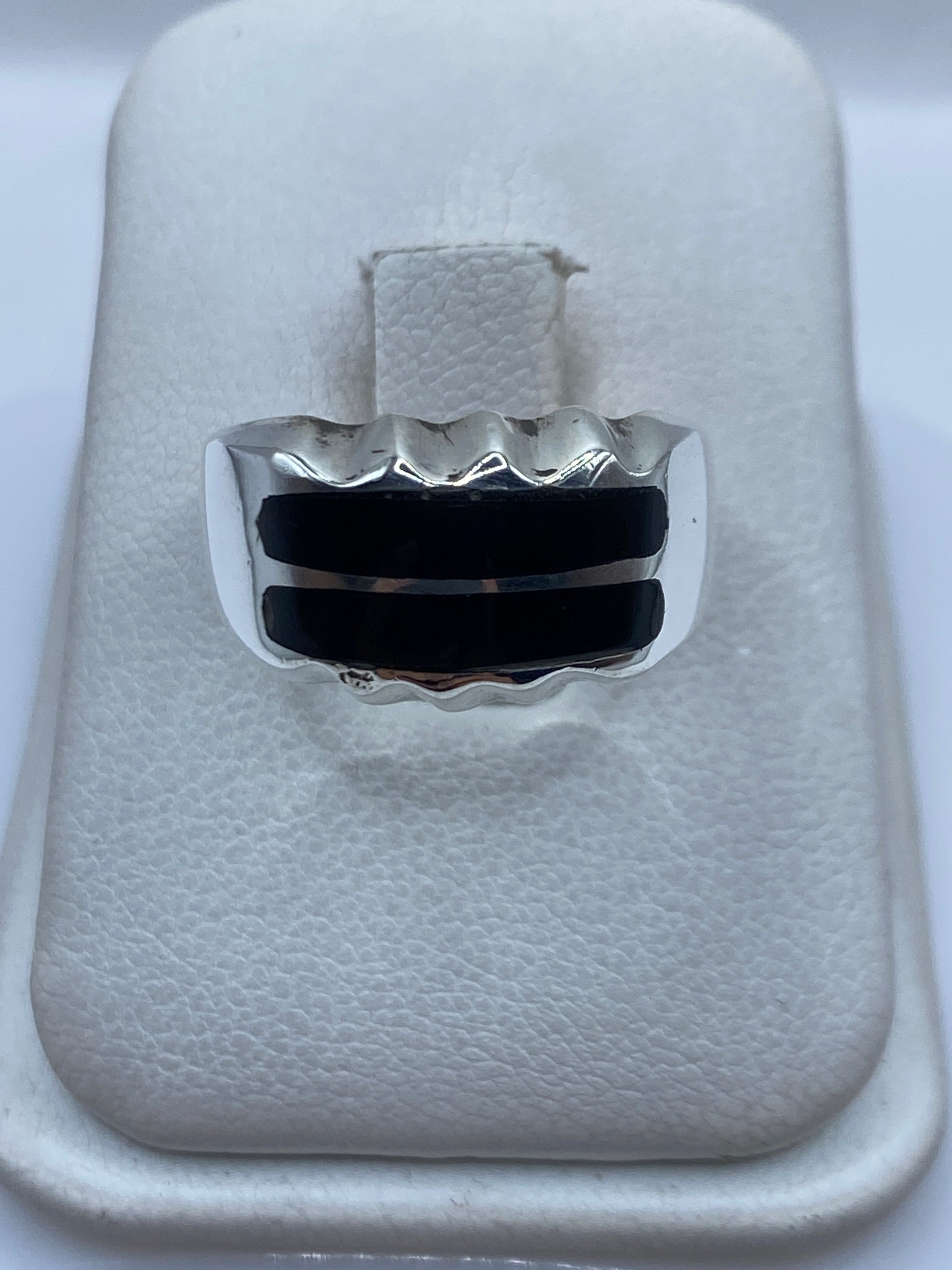 Anillo de plata .925 con dos franjas de ónix negro engastadas, visto de frente en estuche blanco