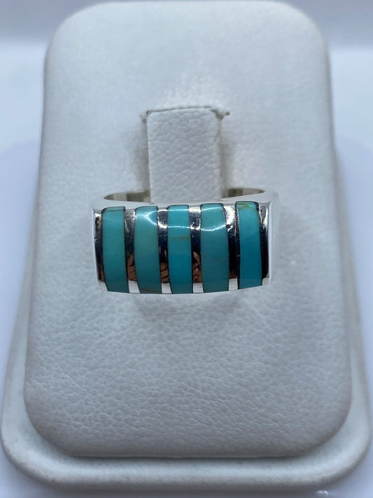 Anillo de plata .925 con cinco piedras de turquesa azul cielo separadas por tiras de plata pulida