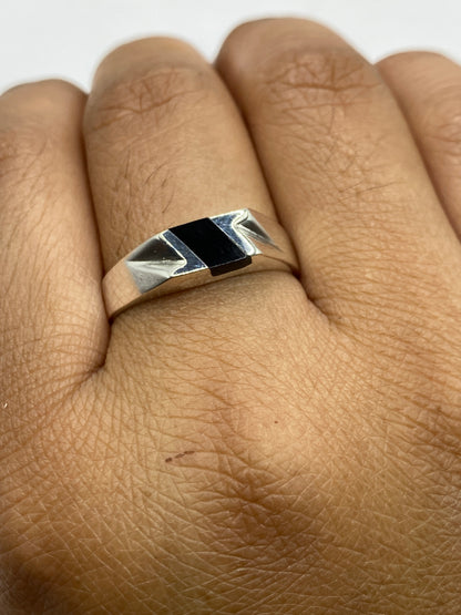 Anillo en dedo mostrando el contraste entre la piedra negra y la plata brillante