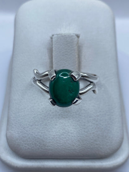 Anillo de plata engastado a mano con malaquita verde en display de joyería