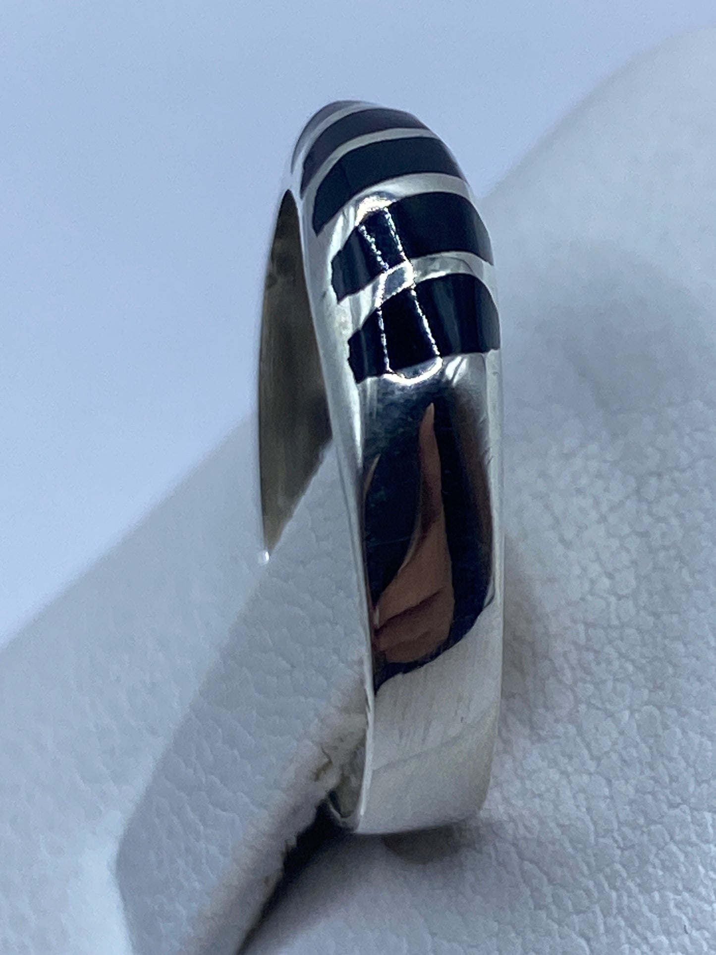 Detalle del ónix negro brillante con bandas de plata pulida