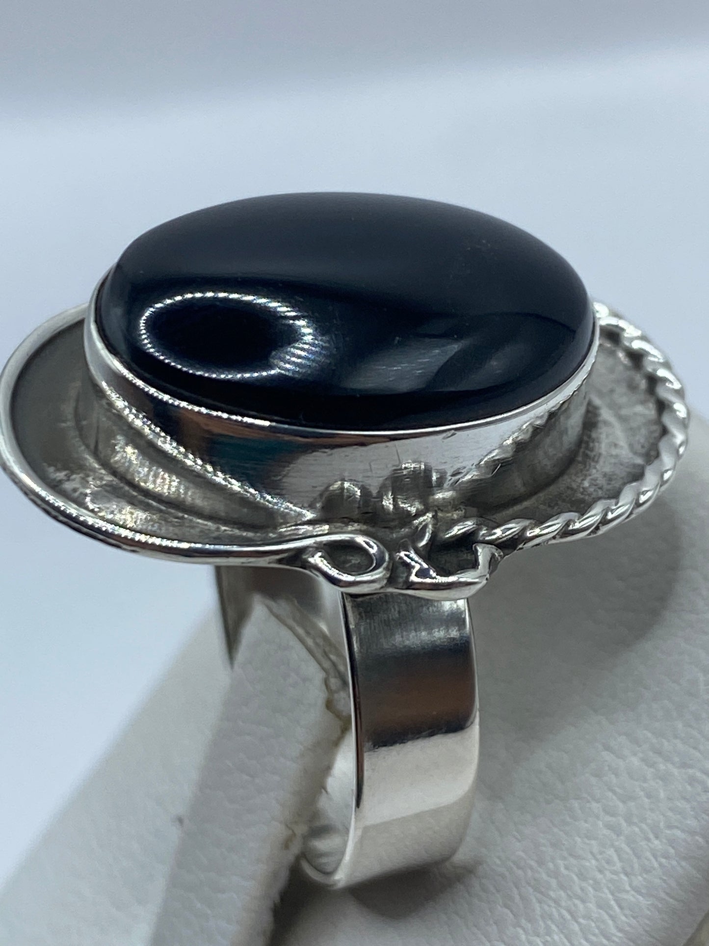 Anillo ajustable de ónix puesto en dedo, mostrando cómo se adapta