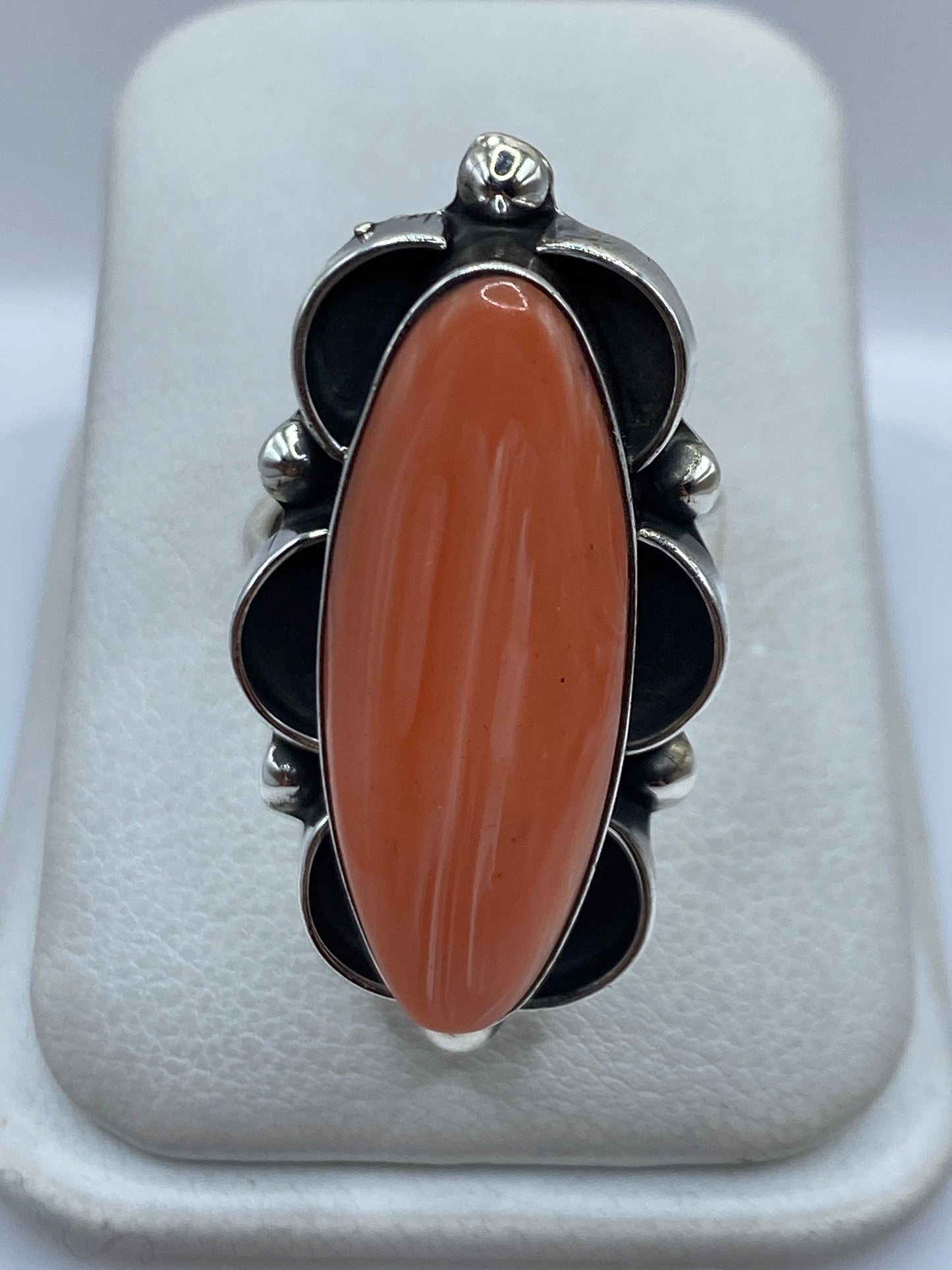 Anillo ajustable de plata .925 con coral naranja rojizo engastado, vista frontal sobre fondo blanco
