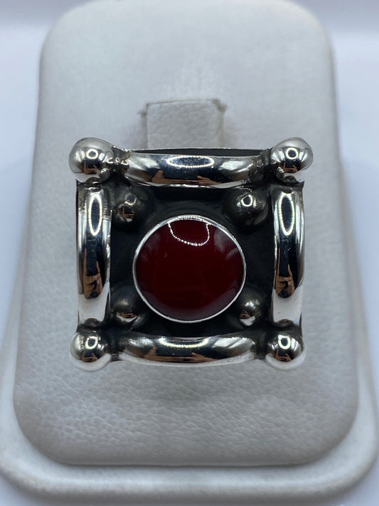 Anillo de plata ajustable con coral rojo engastado en diseño geométrico, vista frontal