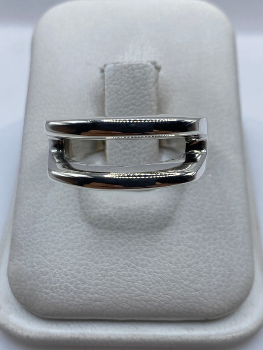 Anillo de plata con técnica de calado minimalista en la mano de una mujer
