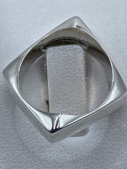 Detalle del anillo puesto en mano masculina, diseño unisex