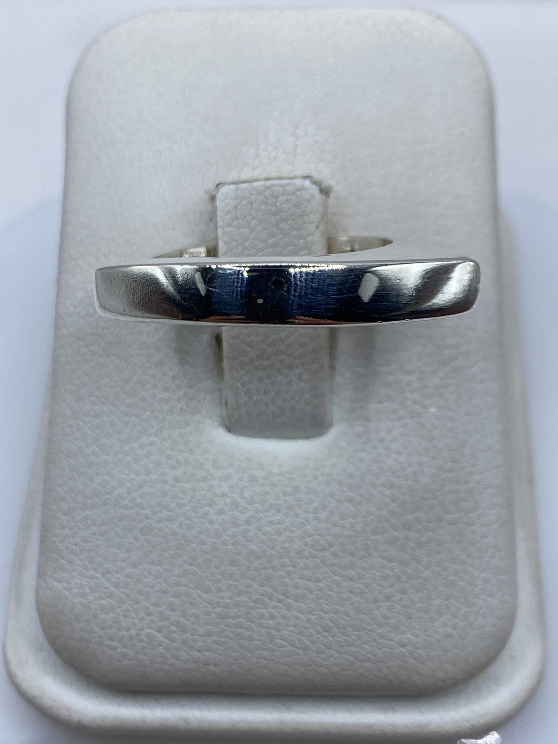 Anillo de plata cartoneado con volumen 3D en la mano de una mujer