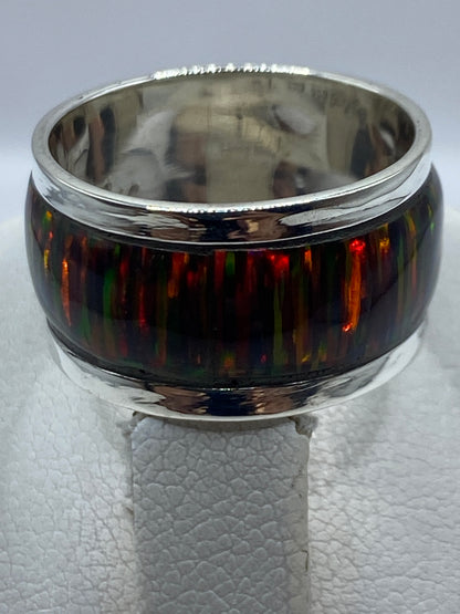 Anillo puesto en mano mostrando los reflejos multicolor del Ópalo de Fuego