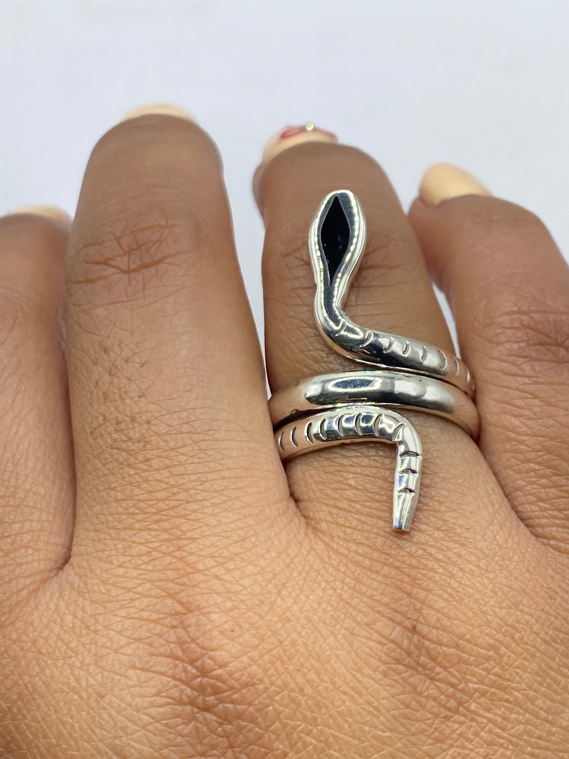 Anillo serpiente en la mano, mostrando el movimiento fluido del diseño y la autenticidad del Quinto