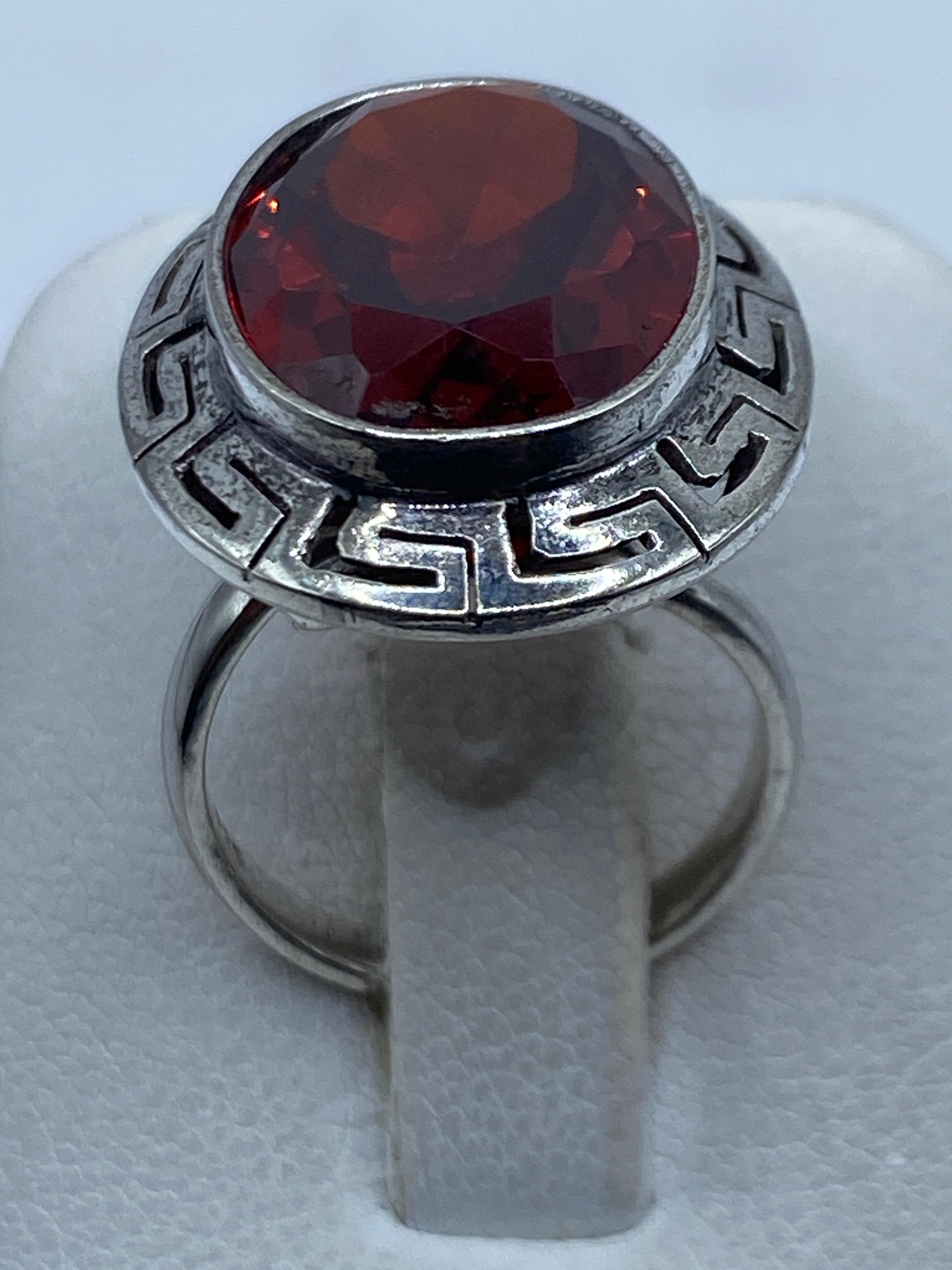 Anillo de plata .925 con circonia roja facetada y marco geométrico prehispánico