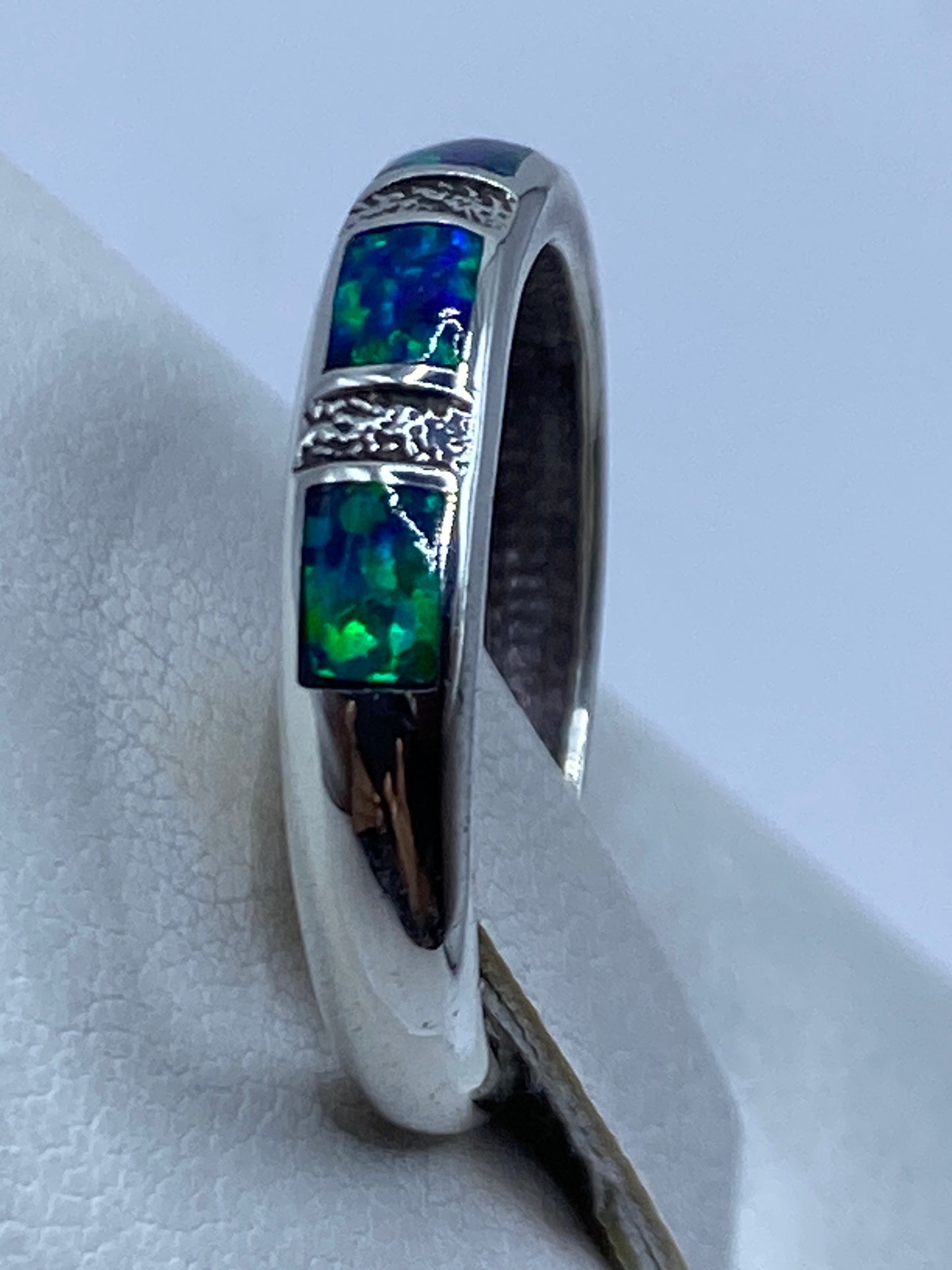Anillo de Ópalo de Fuego puesto en la mano mostrando el color azul y juego de luces