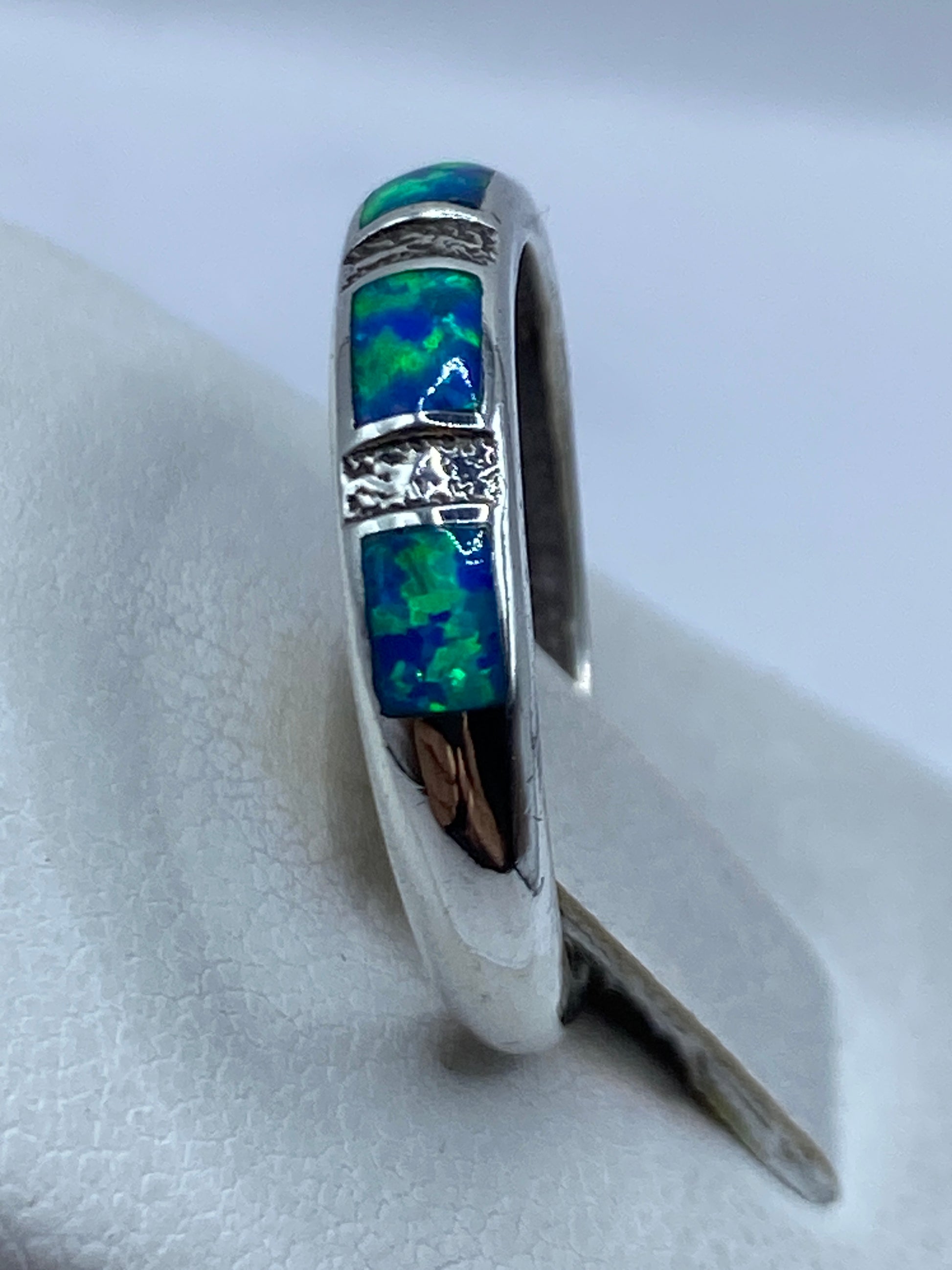 Detalle del anillo en mano de mujer destacando el juego de luz del Ópalo de Fuego