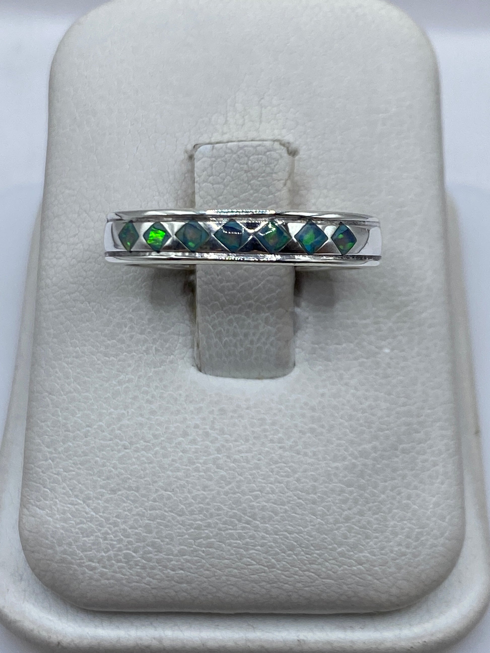 Anillo de plata .950 con Ópalo de Fuego azul cielo engastado a mano, vista frontal sobre anular