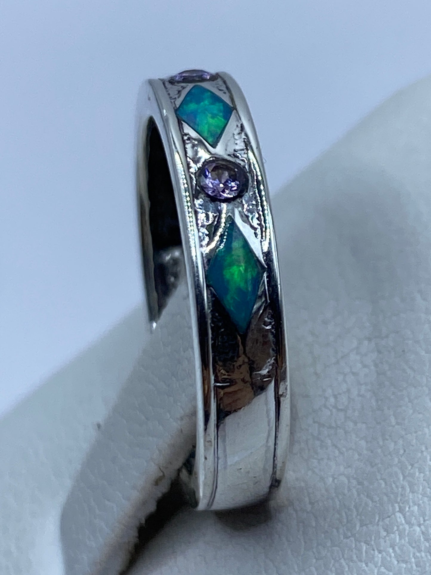 Anillo en el dedo mostrando el brillo y la iridiscencia del ópalo