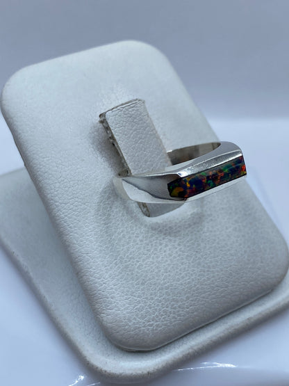 Vista lateral del anillo de ópalo de fuego en plata — diseño de banda sólida
