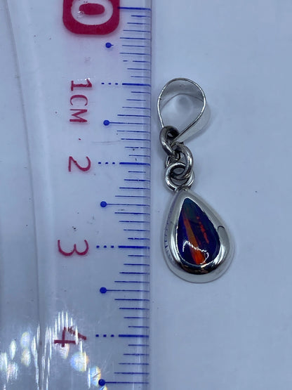 Reverso del dije de plata .950 con Quinto grabado