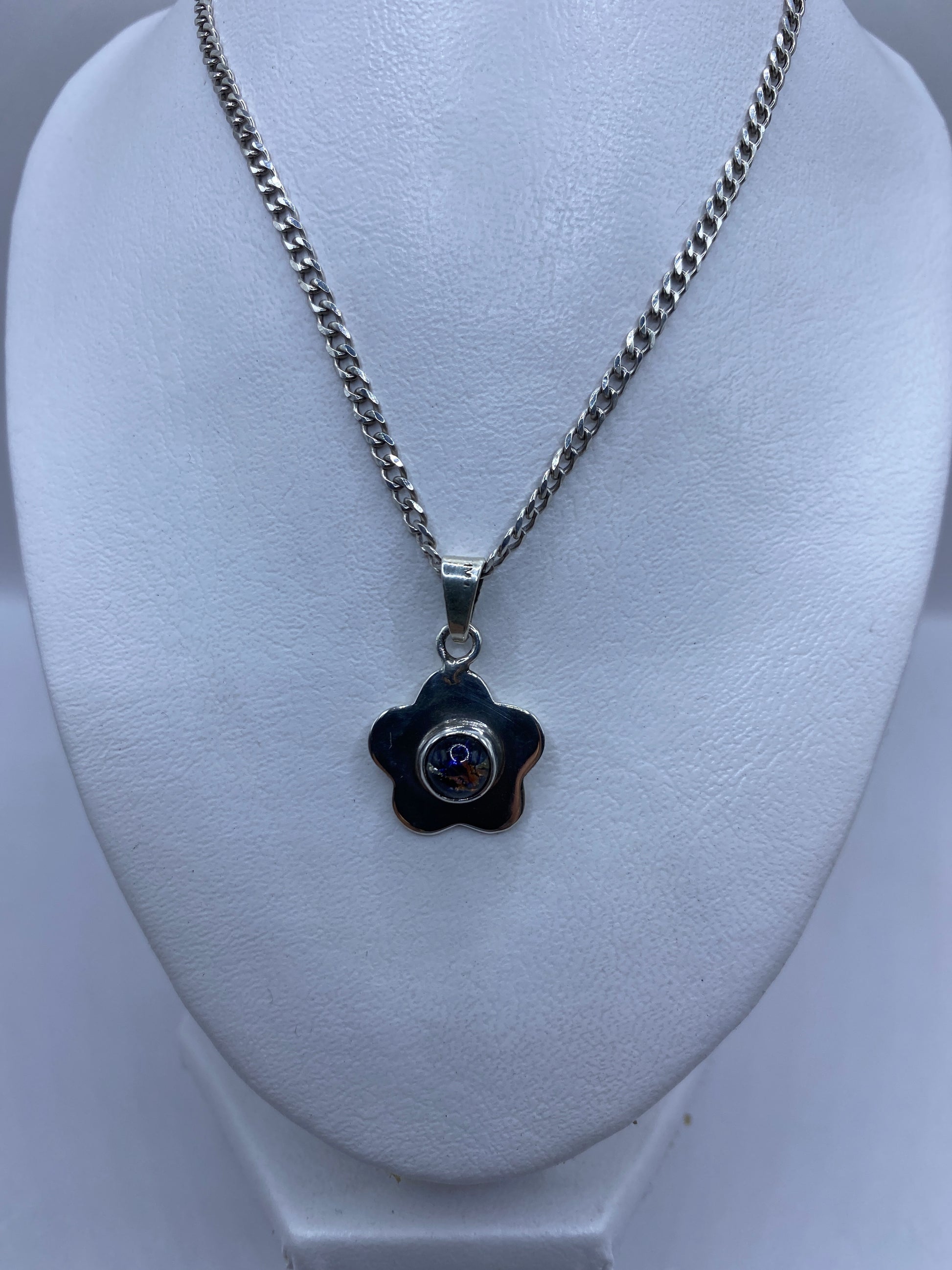 Dije floral de tamaño 3.3 cm en forma de flor con piedras engastadas, vista frontal