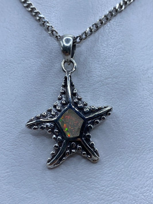 Dije de estrella marina en plata .950 con Ópalo de Fuego multicolor colgando de una cadena curb