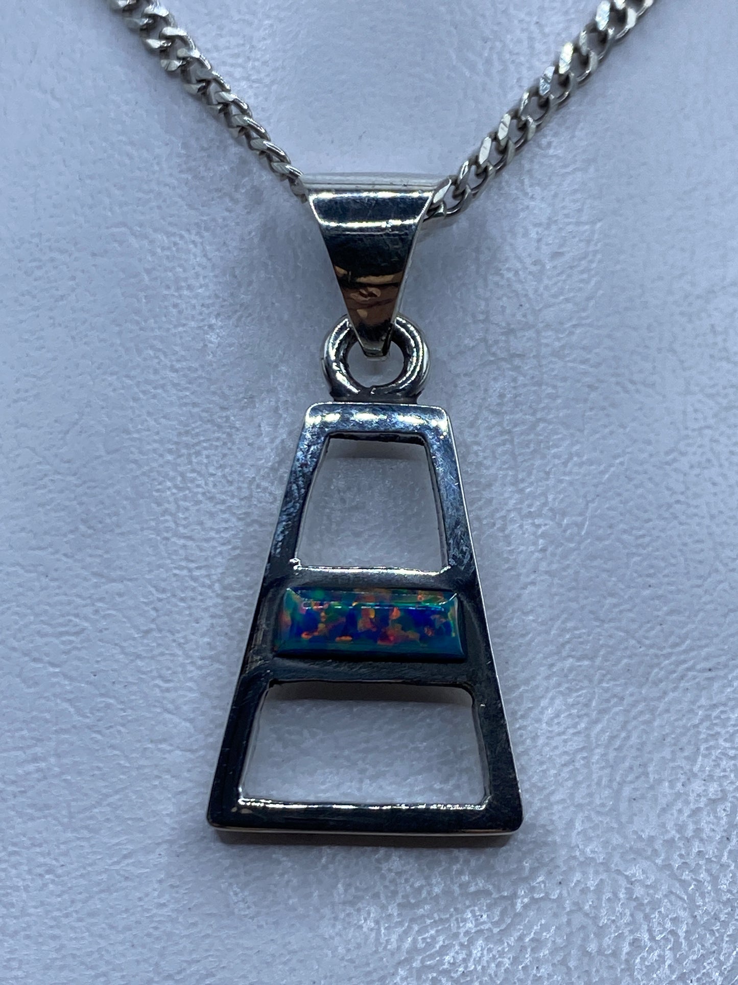 Dije de plata trapezoideal con Ópalo de Fuego azul engastado, colgando de cadena de plata
