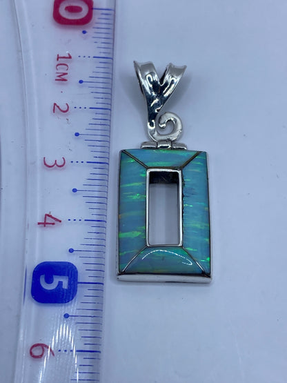 Reverso del dije de plata .950 mostrando el trabajo a mano y el Quinto