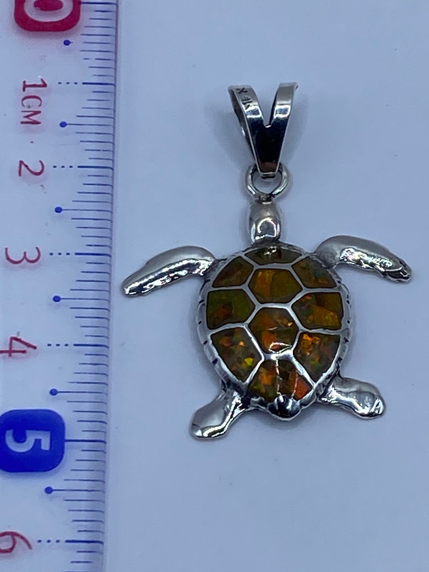 Detalle del reverso del dije mostrando el engaste a mano del ópalo y el grabado del Quinto .950