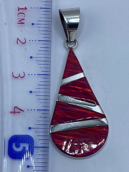 Dije de 5.2 cm junto a regla para escala, peso 2.5 g