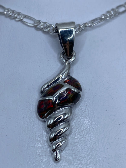 Dije de plata .950 con ópalo de fuego multicolor en tonos naranjas, rojos y verdes