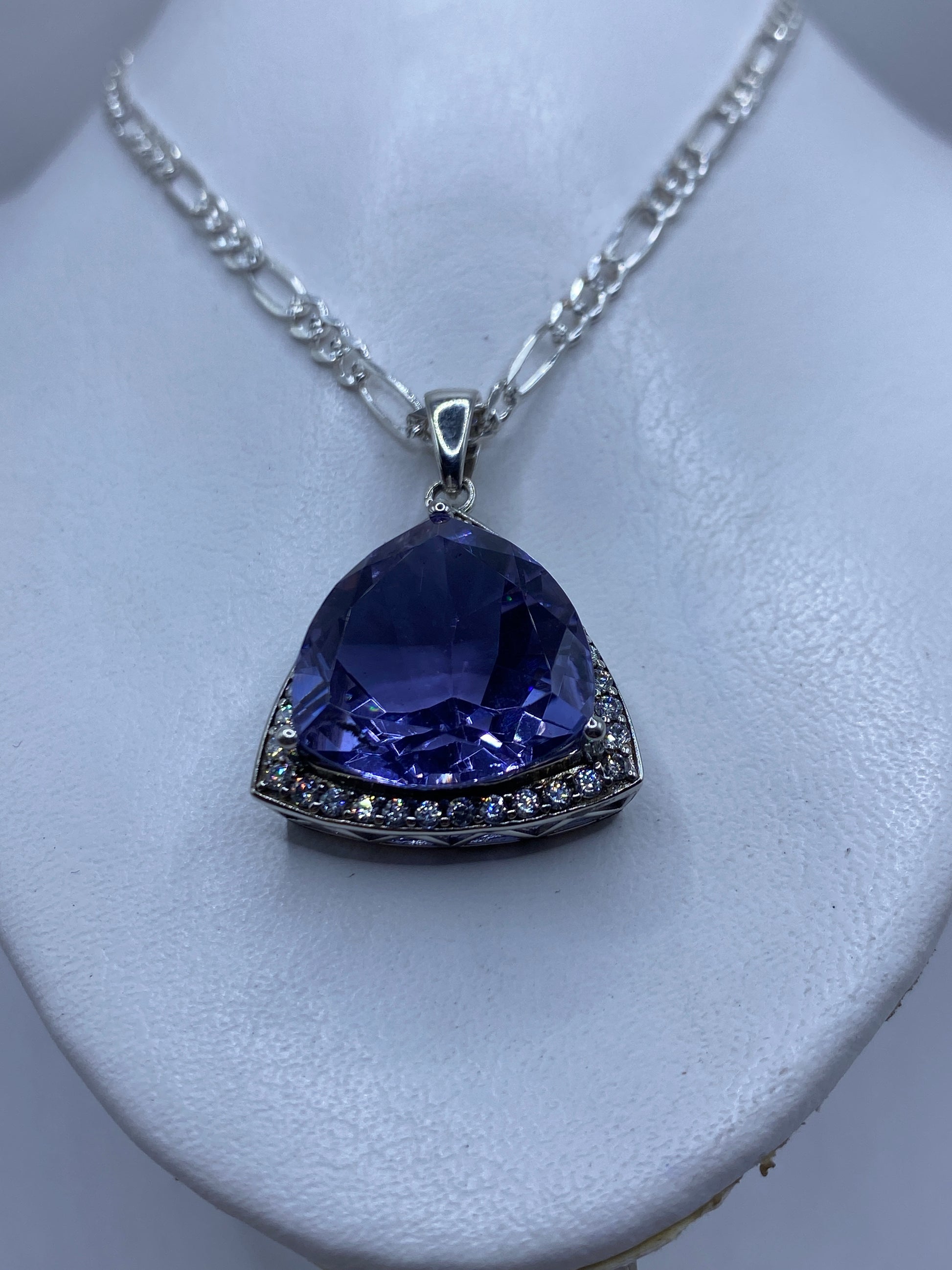 Detalle de la circonia lavanda facetada en el dije triangular